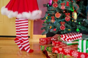 Stocking feet on a hardwood floor next to a Christmas tree