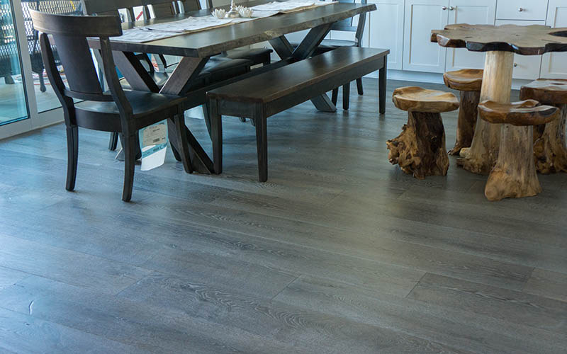 Our Villa Collection hardwood flooring, hand-dyed to perfection, and installed in a dining room.