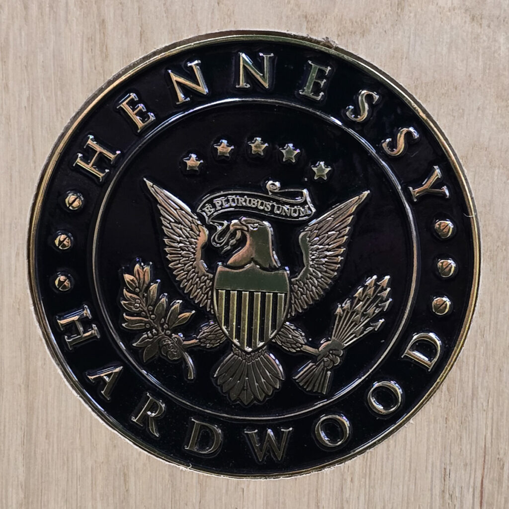 Hennessy Wood logo medallion.